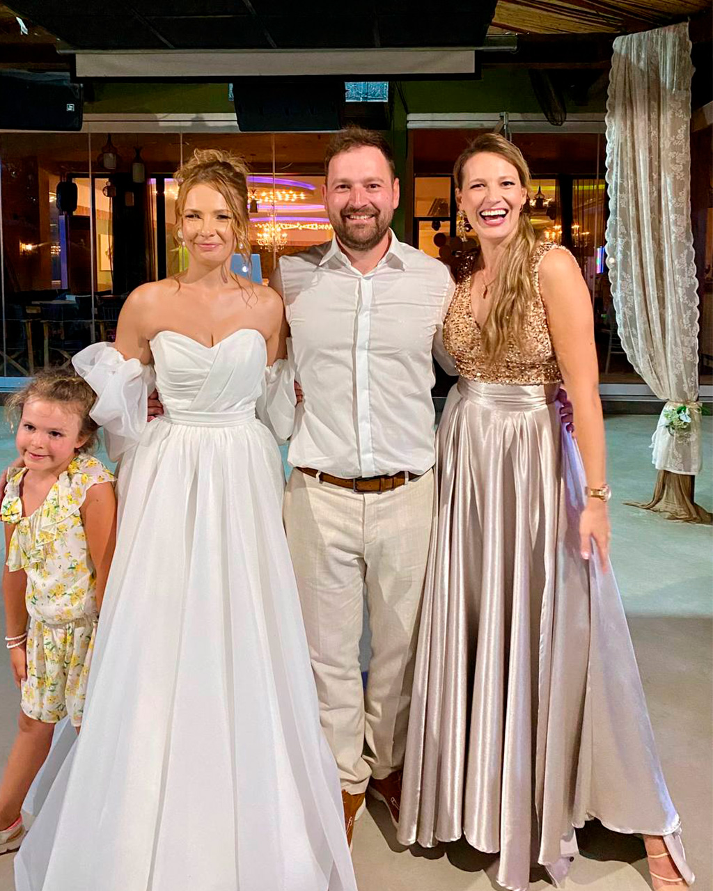 Wedding couple and host smiling